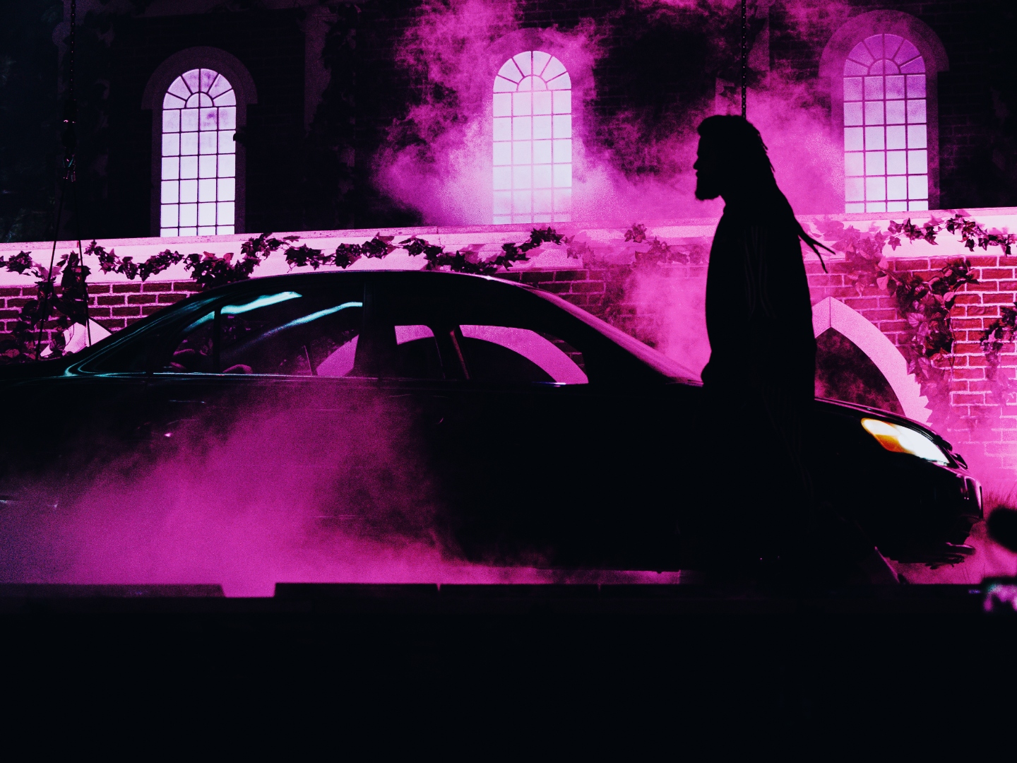 Silhouette against magenta smoke and arched windows in Chicago