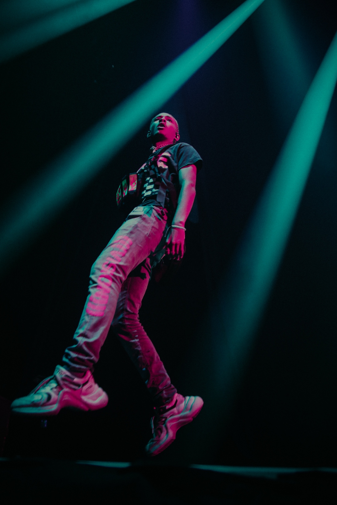 J. Cole airborne under green stage lasers