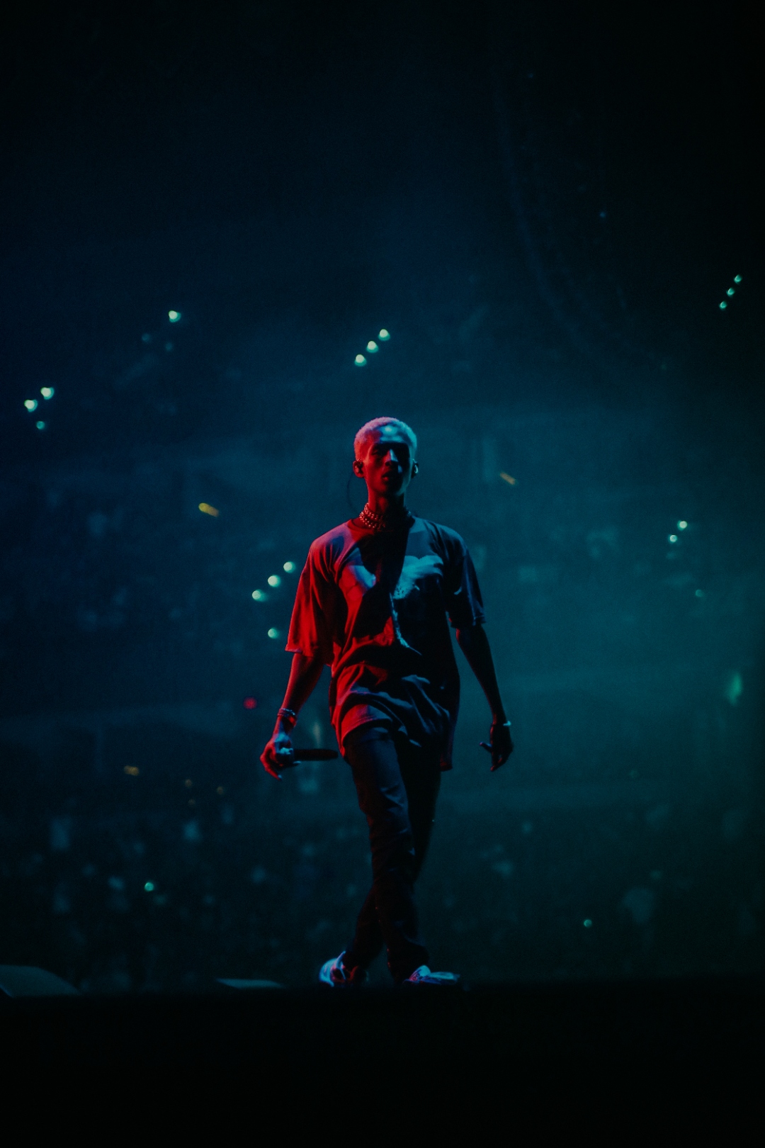 J. Cole in blue haze with lit crowd
